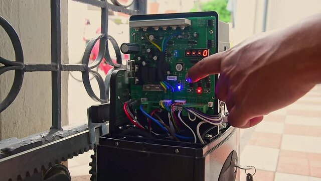Technician installed  and test automatic gate motor system working for control gate home security system