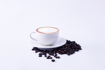 Coffee cup and coffee beans on wooden table.