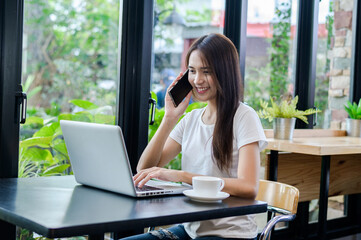 Asian woman or a happy student smiles on a desk with a computer.