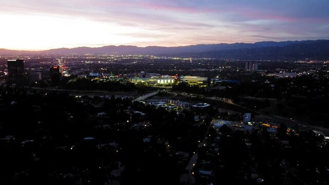 Hollywood Hills/Studio City birds-eye-view at dusk. Panoramic city view at sunset, towards Universal Studios and Warner Brothers. 9s sec.