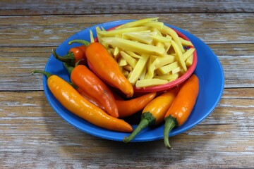 Pile of yellow chilly (yellow pepper) and sliced young pickled bamboo shoot on the plastic plate. Set of ingredients in Thai cuisine. 
