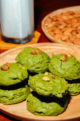 White chocolate matcha  brownie cookies , Almonds and iced milk  in wooden tray  on table, Delicious homemade