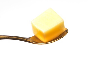 Close Up of Mozzarella Cheese Cubes and Golden Spoon Isolated on White Background
