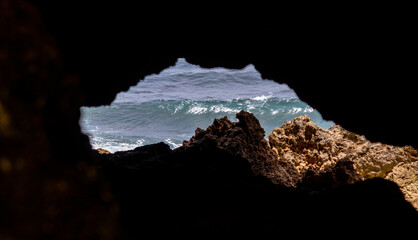 A view of the ocean from a cave