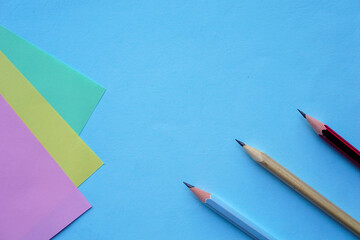 Pastel Color paper and pencil for background. minimalist back to school copy space concept for text.