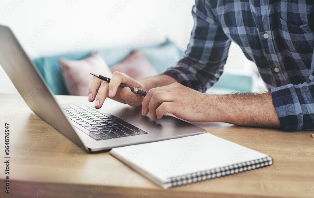 Wall mural male student studying online using laptop. online education concept