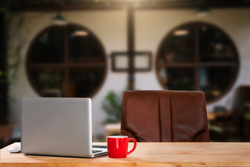Laptop with blank screen on white desk with blurred background as concept