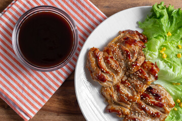 dish of teriyaki chicken with salad, corn and ssame seeds	