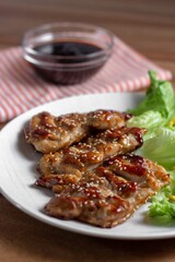 dish of teriyaki chicken with salad, corn and ssame seeds	