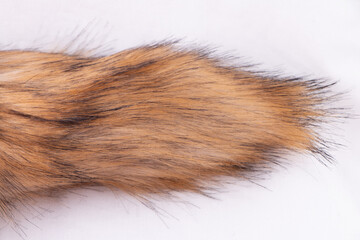 Artificial fox faux fur fluffy tail isolated on white
