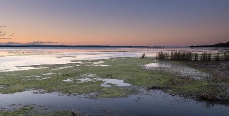 Panorama Sunset and soft shades pf pink and green over the Lake