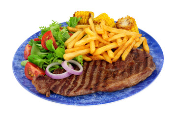 Grilled sirloin steak and French fries meal with fresh salad and sweetcorn cobs isolated on a white background