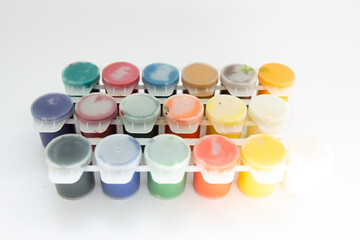 jars with gouache paints on a white background
