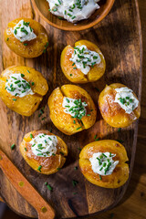 Oven baked potatoes with sour cream with butter and chives