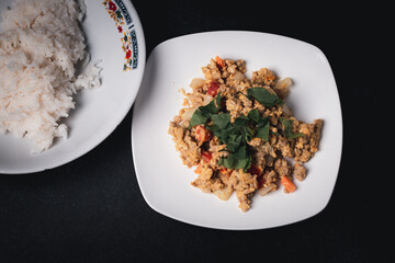 Stir-fried minced pork curry powder in a white plate