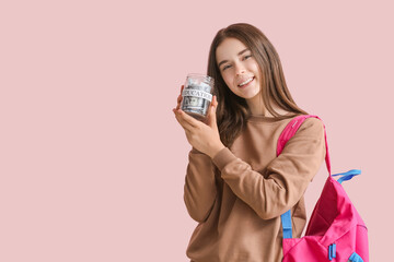 Teenage girl with savings for education on color background