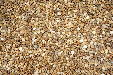 Brown pebbles with natural pattern as background.  Gardening, landscaping and construction ideas. 