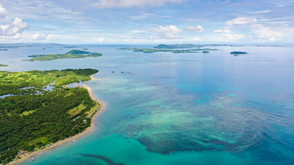 Plakat Malay archipelago with reefs and islands. Seascape with islands in the early morning, aerial drone. Beautiful landscape on the island of Luzon. Caramoan Islands, Philippines.