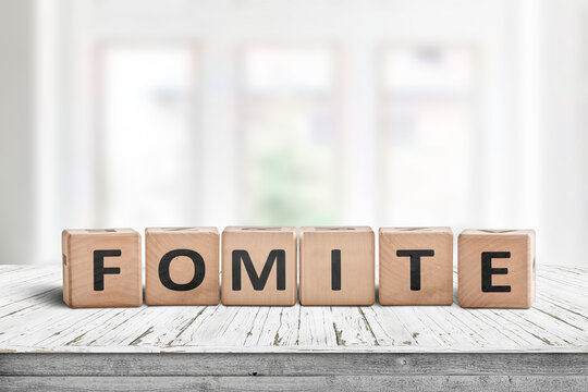 Fomite sign made of blocks on a wooden table