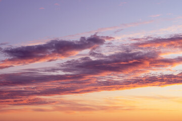 Naklejka na ściany i meble Cloudy sunset in orange and violet colors