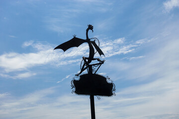 Iron forged dragon against the sky