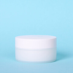 White cream container. Isolated on blue background, copy space.