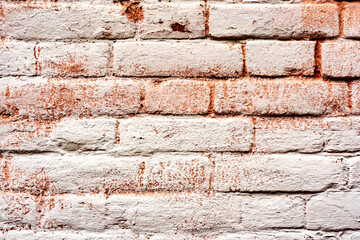 Texture of a brick wall with cracks and scratches which can be used as a background