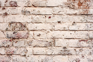 Texture of a brick wall with cracks and scratches which can be used as a background