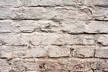 Texture of a brick wall with cracks and scratches which can be used as a background