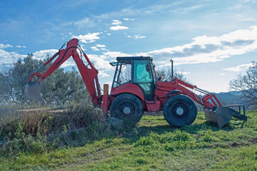Tractor with backhoe in action