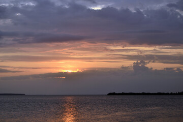 Dramatic background of the sunset with orange sky and sea.