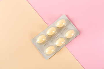 Tablets in strip over pink background, vaginal antibacterial capsules
