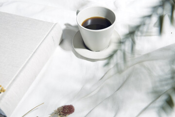 白い布とコーヒーカップのある窓辺