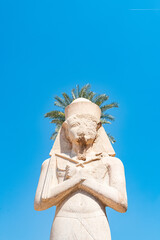 Statue of Rames II at Karnak temple with blue sky at background in Luxor,  Egypt