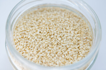 sesame in a jar on a white background