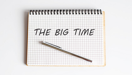 Concept THE BIG TIME message on notebook on white background