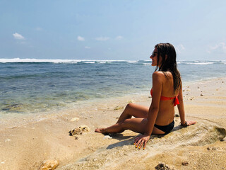 Young woman enjoying summertime in the ocean / sea water.