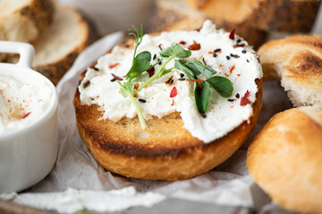 toasted buns with curd cheese and fresh herbs