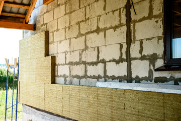 House thermal insulation mineral wool slabs. Inside wall heat isolation with mineral wool.