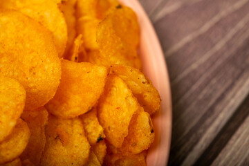 Potato chips on a round platter. Close up.