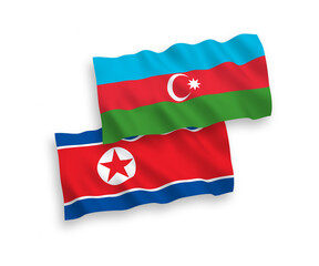 Obraz premium National vector fabric wave flags of North Korea and Azerbaijan isolated on white background. 1 to 2 proportion.