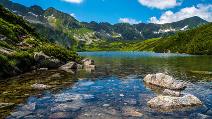 Naklejka na ściany i meble Rocks in a big pond in the Tatra Mountains