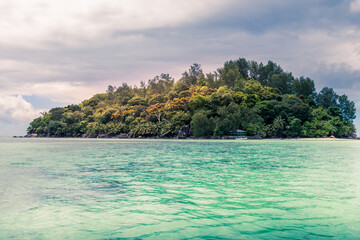 Tropical and heavenly beach with blue sky, coconut trees, white sands, crystal clear waters, surrounded by huge granite boulders rocks at seychelles islands