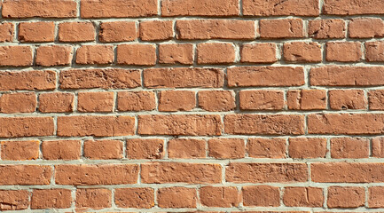 Old brick wall. Brickwork from an old brick in a rustic style. The structure and pattern of the destroyed stone wall. Copy space.