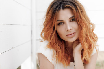 Portrait of a young smiling happy ginger woman outdoor