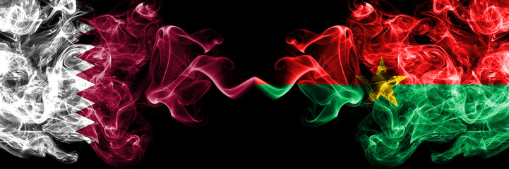 Qatar vs Burkina Faso smoky mystic flags placed side by side. Thick colored silky abstract smoke flags.