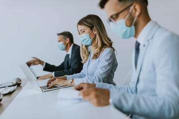 Group of business people have a meeting and working in office and wear masks as protection from...