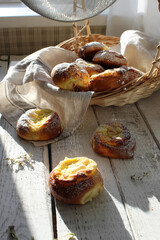 Fresh cheesecakes in a basket on a wooden table in the sun. Homemade cake. Confectionery.