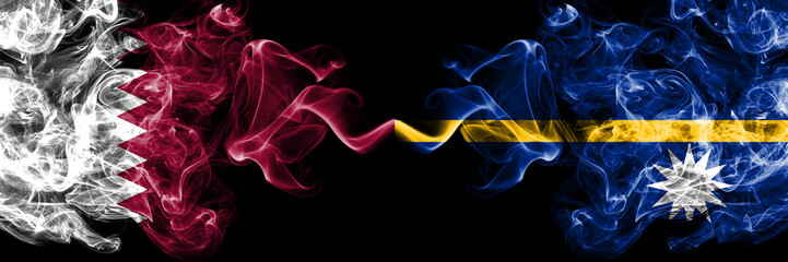 Qatar vs Nauru smoky mystic flags placed side by side. Thick colored silky abstract smoke flags.