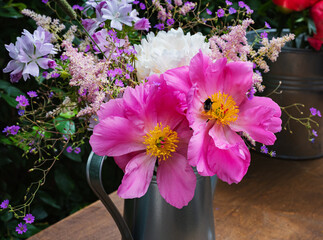 summer bouquet of blooming peonies and wildflowers